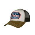 A trucker-style baseball cap with a white front panel, black mesh back, and olive brown brim. The front panel features a prominent embroidered logo that reads 'American Heritage Stetson Since 1865' in red, white, and blue.