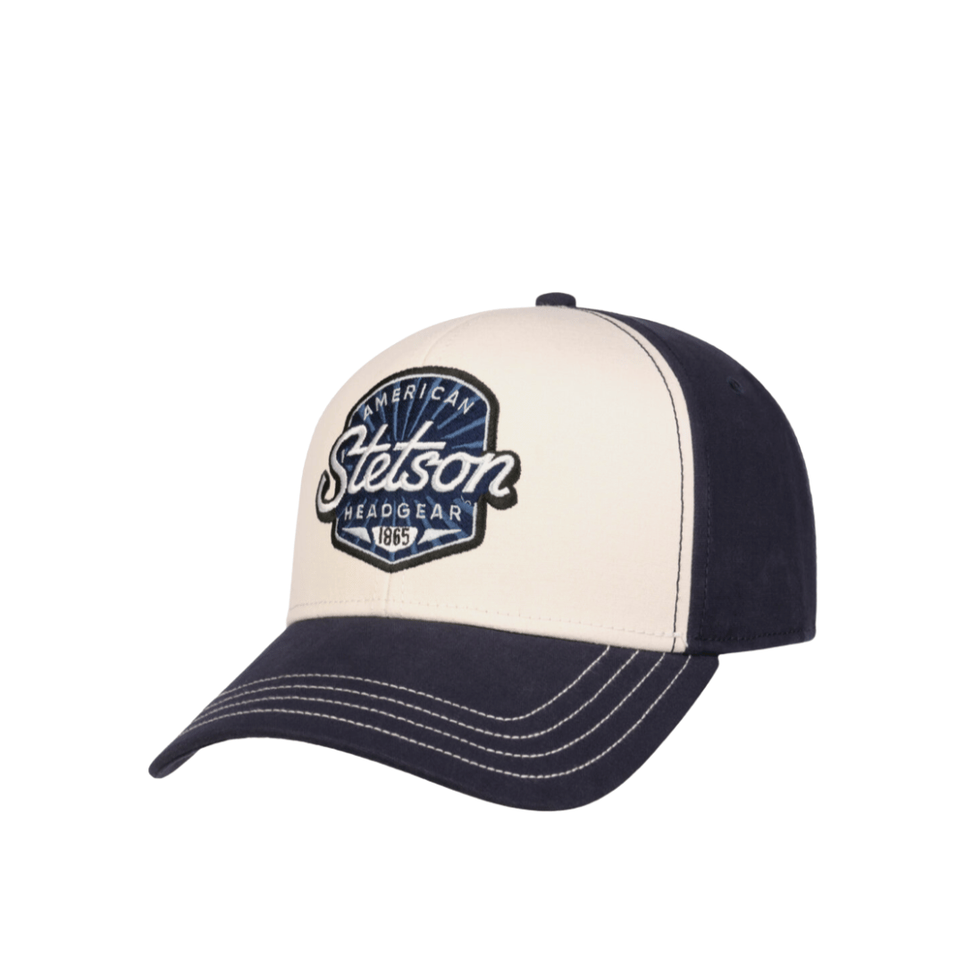 A Stason brand baseball cap with a cream-colored front panel and a navy blue curved brim, featuring a matching navy blue back panels. The front panel has a prominent embroidered Stason Headgear logo patch.
